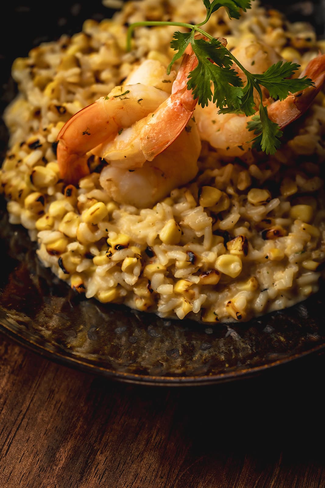 Corn and queso risotto topped with shrimp