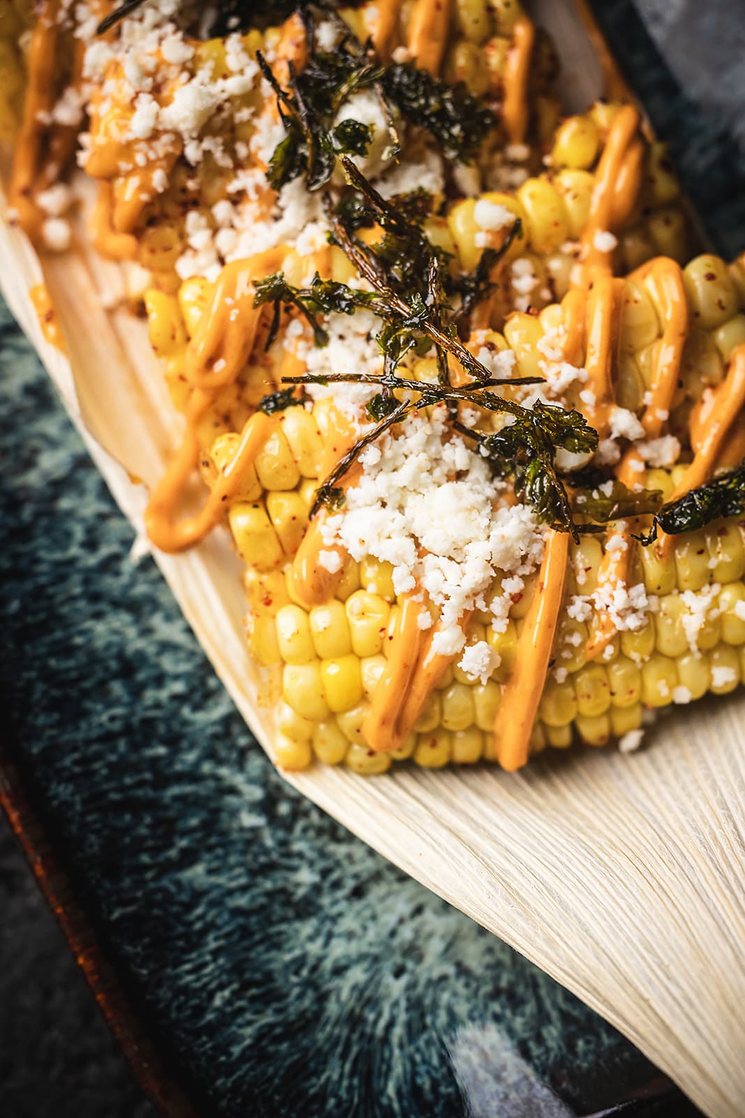 Mexican rib-style elote with queso fresco and chipotle aioli