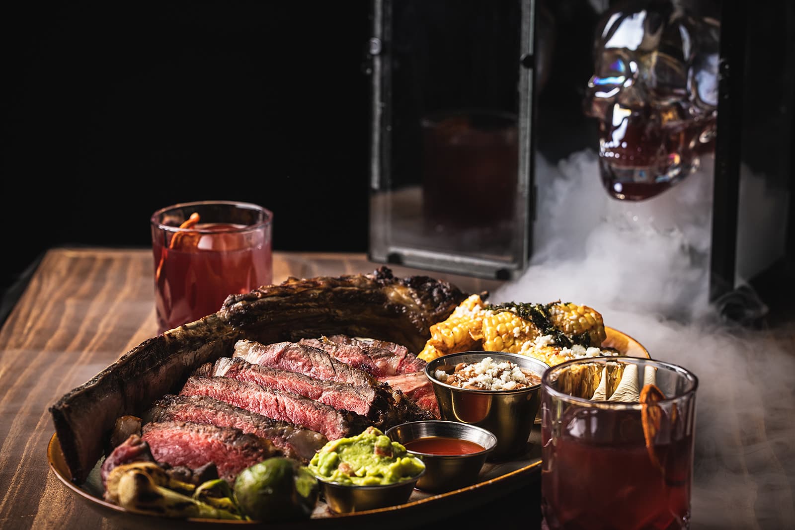 Tomahawk steak with cocktails and tableside smoke