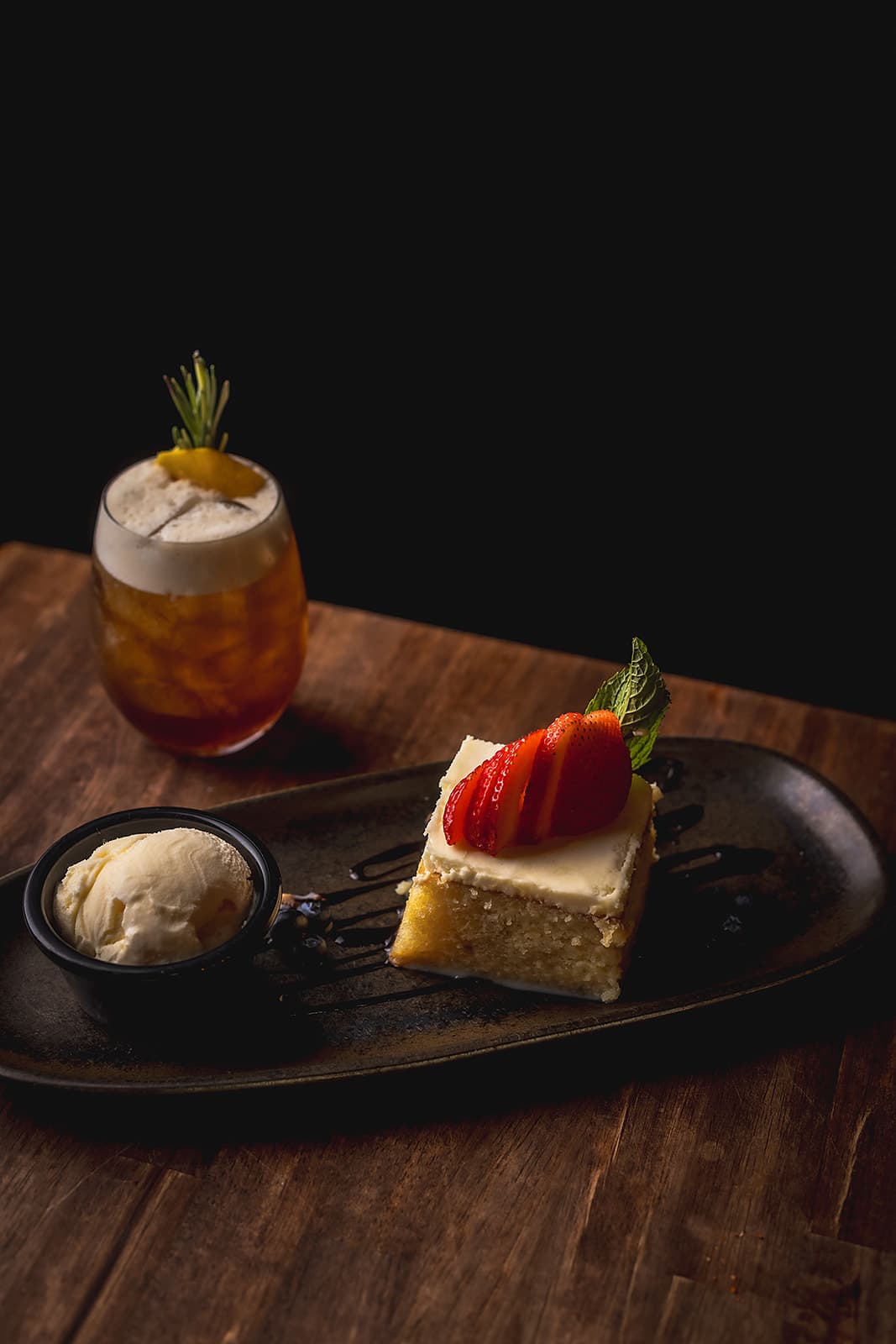 Tres leches cake with strawberries and ice cream